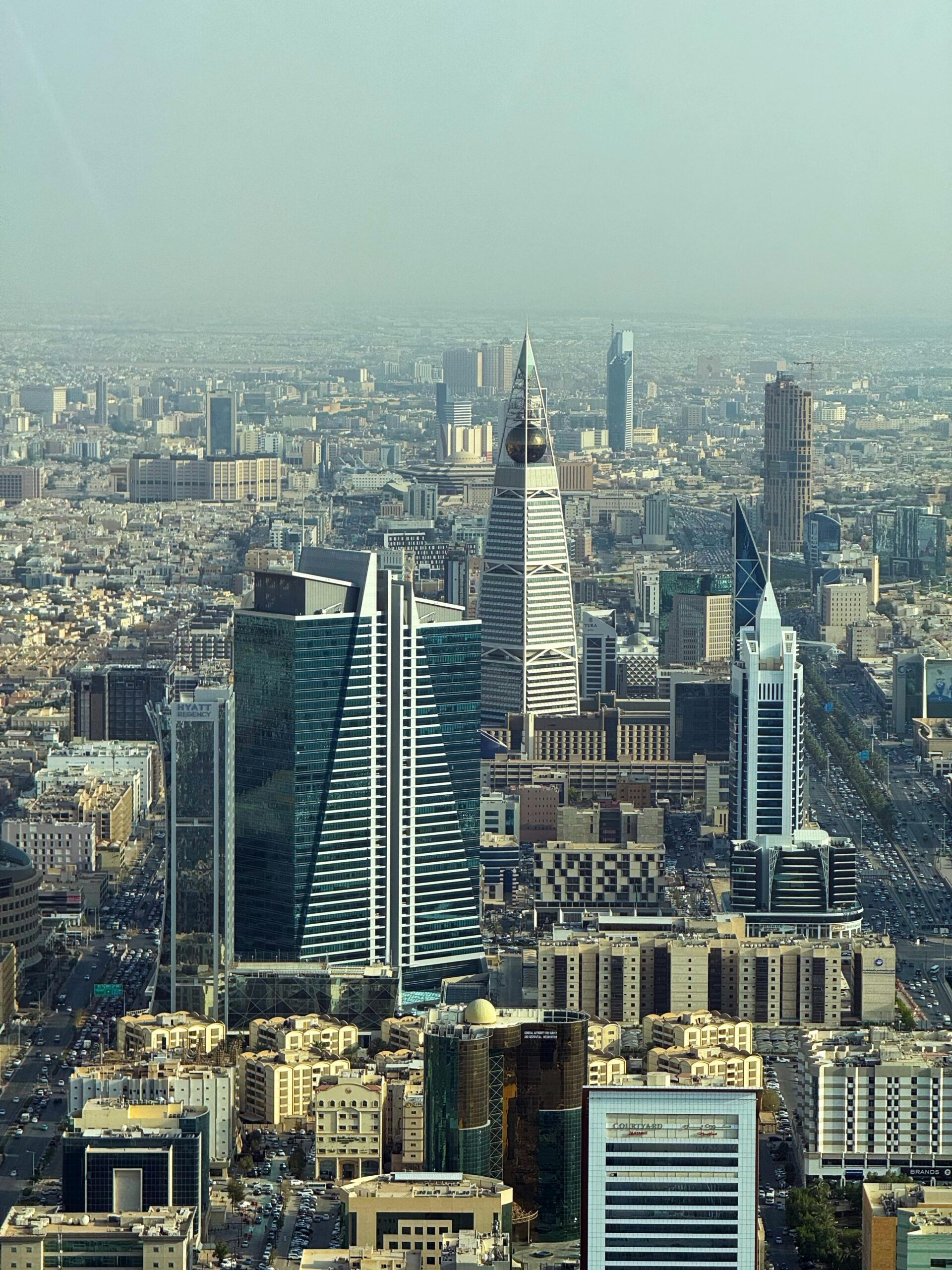 Aerial view of Riyadh's skyline featuring modern skyscrapers on a clear day.